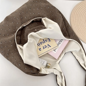 Detail view of large corduroy tote bag showing interior lining and floral pattern