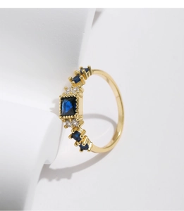 Detail view of square blue gemstone and side diamonds on the gold S925 silver ring