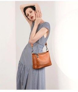 Detailed view of brown snakeskin pattern PU leather handbag with gold metal hardware