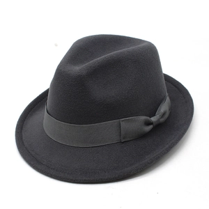 Dettaglio cappello fedora in lana grigio scuro con nastro grosgrain e fiocco su sfondo bianco