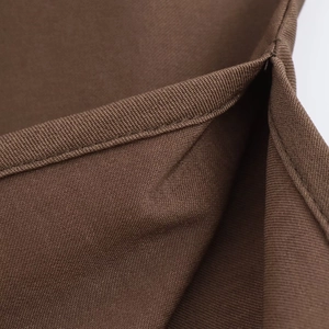 Macro view of brown fabric texture and double-stitched reinforced seam details