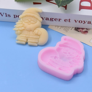 Close-up of pink silicone Santa Claus mold with detailed beige finish cake toppers