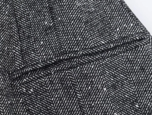 Detailed close-up showing the premium grey herringbone wool texture and stitching