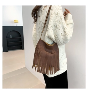 Detailed back view of a brown tassel shoulder bag with vibrant yellow inner lining