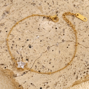 Detail of 18K gold-plated star pendant bracelet with micro-pave diamonds on stone