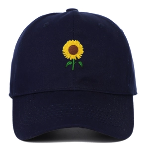 Close-up of sunflower embroidery on navy blue cotton baseball cap with fine stitching