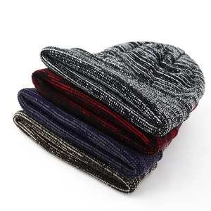Detailed view of four mixed-color knitted beanies in black, red, blue, and brown tones