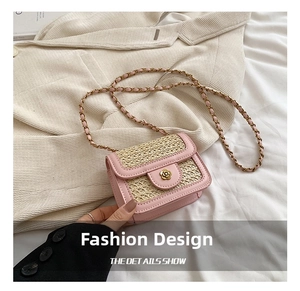 Detailed shot of pink woven leather bag featuring a gold flower buckle and chain strap