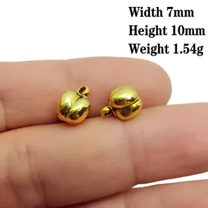 Macro detail of antique gold peanut charm showing 10mm height and 7mm width dimensions