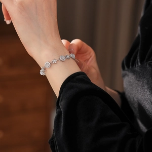 Detail of flower bracelet with micro-pave zircons and white chalcedony on female wrist