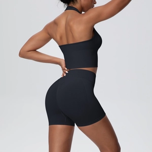 Close-up of black seamless ribbed knit yoga set showing backless top and lift shorts