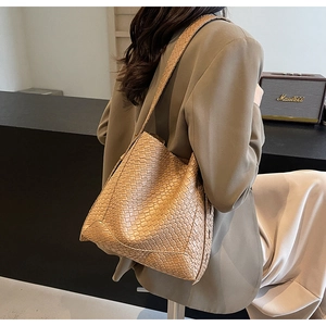 Detailed close-up of khaki woven tote bag showing premium braided texture and PU leather