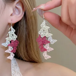 Pink gradient butterfly tassel drop earrings featuring a delicate hollow metal design