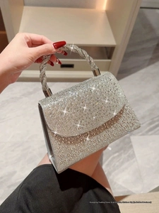 Silver rhinestone evening bag with sparkling hand-set crystals and a twisted top handle