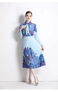 Detail of the blue floral pleated dress showing the lapel collar and sharp pleating texture