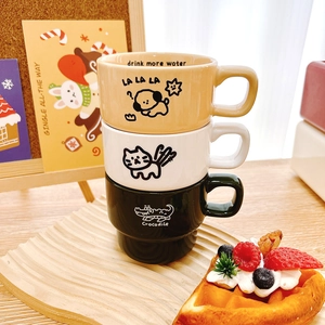 Three stackable ceramic mugs with cartoon dog, cat, and crocodile patterns for coffee