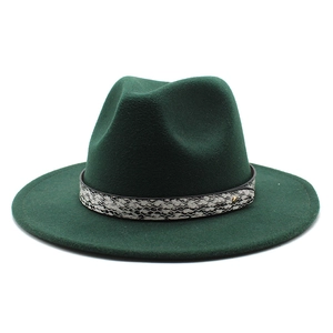 Detail of dark green wide-brim wool fedora with snakeskin leather band and gold stud