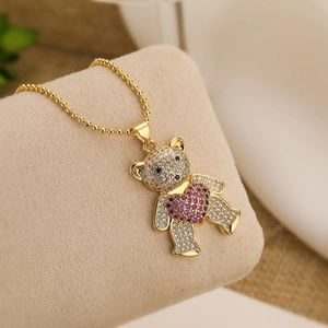 Gold plated teddy bear necklace with clear zircons and a pink crystal heart pendant