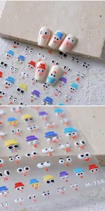 Detailed view of cartoon face nail art stickers M-716 applied on white false nails