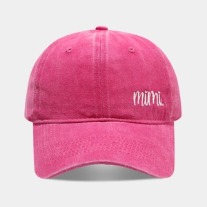 Close-up of mimi embroidery on washed cotton baseball cap in vibrant magenta pink color