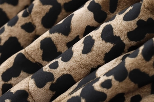 Macro shot of leopard print fabric texture with sharp diagonal twill patterns