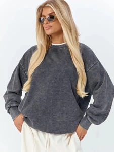 Detailed acid wash texture and stone-washed finish on a charcoal grey oversized sweatshirt