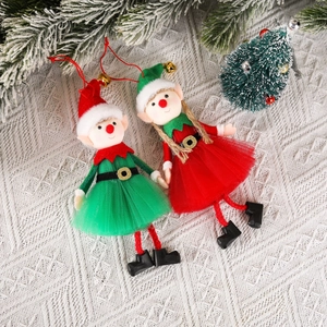 Pair of Christmas elf doll ornaments in red and green colors hanging on white knit fabric