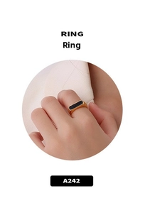Detail of minimalist 18K gold plated ring with a rectangular black enamel inlay for women