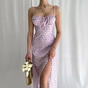 Close-up of a floral summer dress featuring a thigh-high slit and ruched bust details