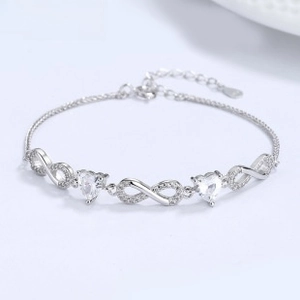 Detail of 925 sterling silver infinity bracelet with heart crystals and lobster clasp