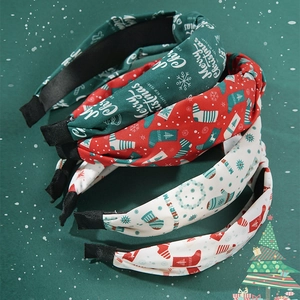 Set of four festive knotted Christmas headbands with holiday prints in red and green