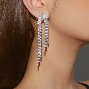 Close-up detail of silver rhinestone long tassel earrings for weddings and gowns
