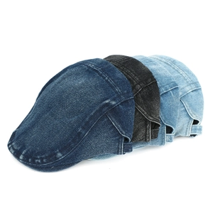 Close-up of washed denim ivy caps in four colors showing stitching and fabric texture
