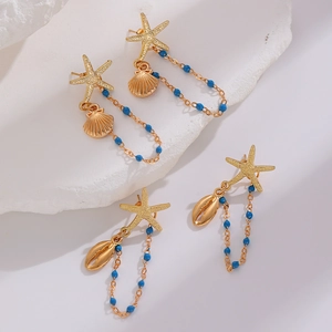 Close-up of bohemian starfish earrings with gold tassels and bright blue beads