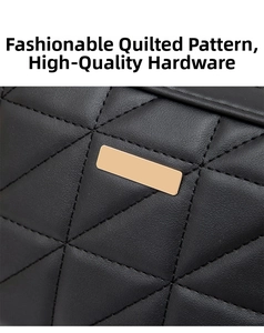 Detail of black quilted leather crossbody bag with elegant gold metal logo plate decor