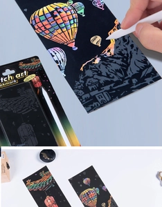 Rainbow scratch art bookmark kit with stylus tool showing finished city night view designs