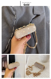 Macro detail of golden rhinestone mini clutch bag with metal chain strap and shimmer finish