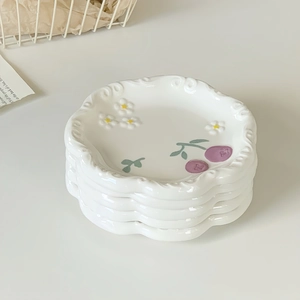 Set of four 6-inch white ceramic plates with floral petal edges and purple cherry patterns