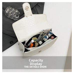 Internal storage view of white crocodile pattern shoulder bag with phone and lipstick