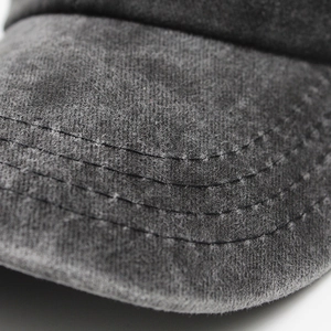 Detailed macro view of heavy washed cotton fabric and precise four-row brim stitching
