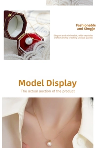 Detail of single pearl pendant on fine 18K gold chain with elegant red jewelry gift box