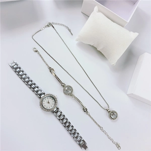 Silver quartz watch and rhinestone jewelry set with bracelet and necklace on white display
