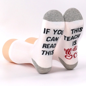 Detail showing 'If you can read this teacher is off duty' print on cotton socks