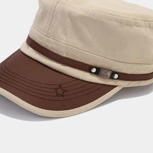 Detailed close-up of army cap featuring leather brim with star stitching and FS FASHION metal plate