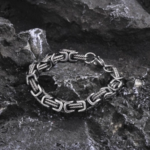 Macro detail of men's vintage Byzantine link bracelet with oxidized silver finish on stone