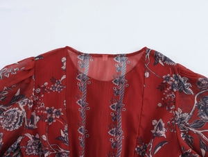 Detailed view of floral print on red chiffon fabric with single-breasted buttons