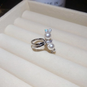 Close-up of double-layer silver ring with gradient pearls and sparkling zircons