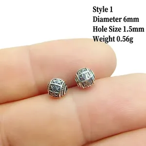 Macro detail of 6mm silver alloy lantern bead with engraved masonic symbol for DIY jewelry