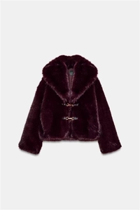 Detail of burgundy faux fur jacket featuring plush texture and gold horsebit buckles