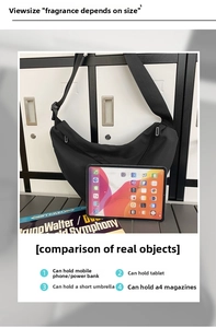 Detail of spacious black crescent crossbody bag showing capacity for A4 magazines and iPad